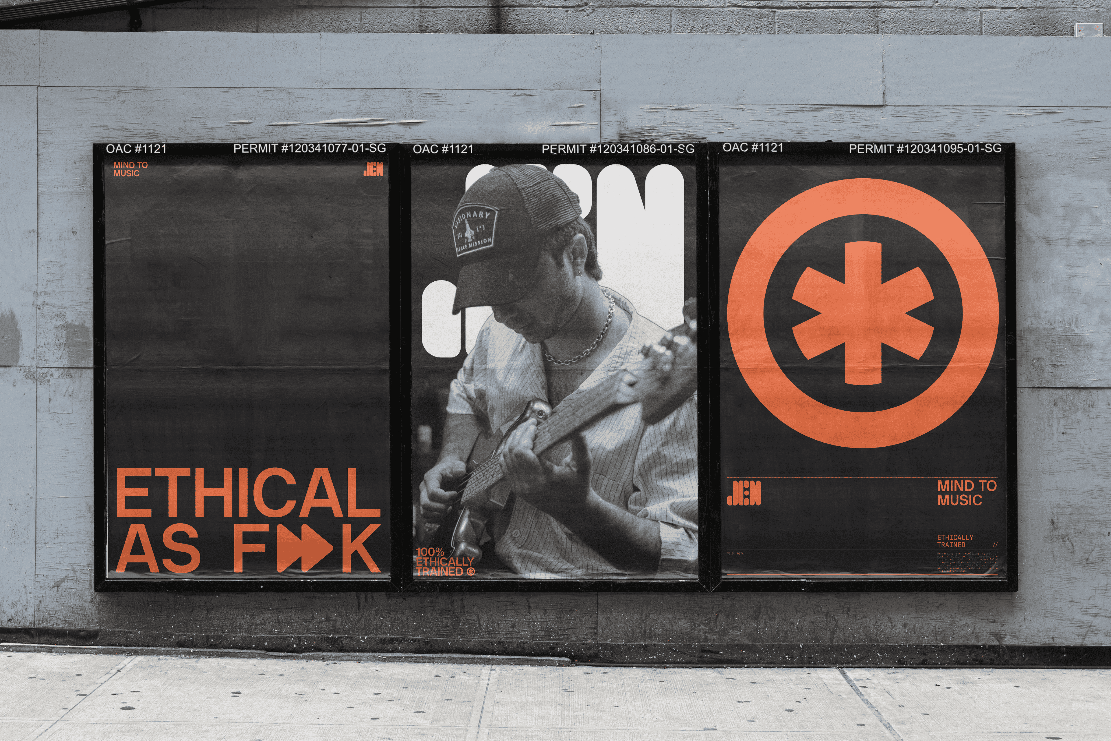 Three framed JEN posters — “Ethical as F▶▶k,” a guitarist, and the asterisk logo — mounted on an outdoor wall.
