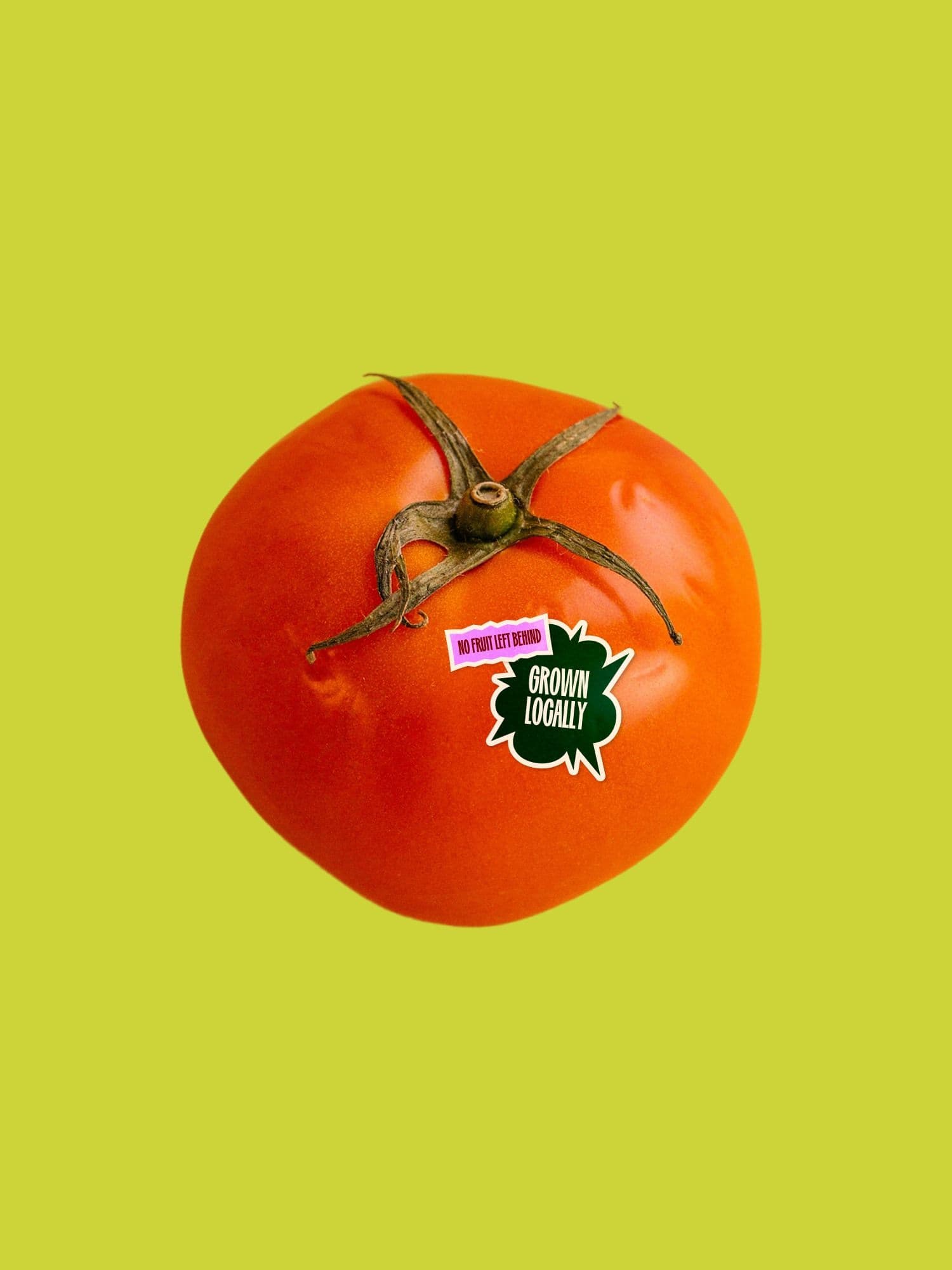 Red tomato on a lime-green background with stickers reading NO FRUIT LEFT BEHIND and GROWN LOCALLY.